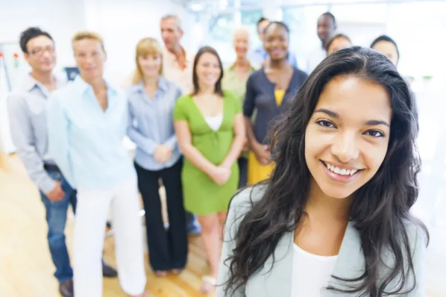 photo of beautiful young woman with colleagues