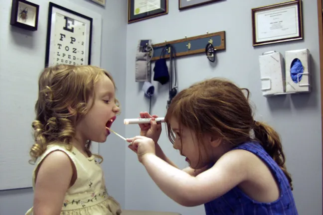 girls playing doctor in exam room