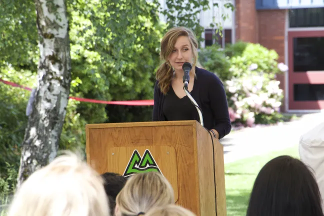 Centennial High School senior class president Jacque Nelson addresses the crowd during the clinic's grand opening.