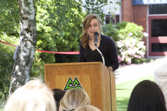 Centennial High School senior class president Jacque Nelson addresses the crowd during the clinic's grand opening.