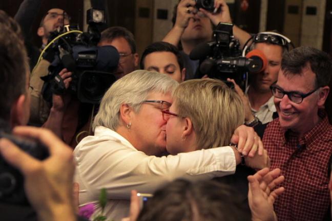 Deanna Geiger and Janine Nelson kiss after receiving their marriage license from the county. Geiger and Nelson were one of two couples who successfully sued the state for the right to marry.