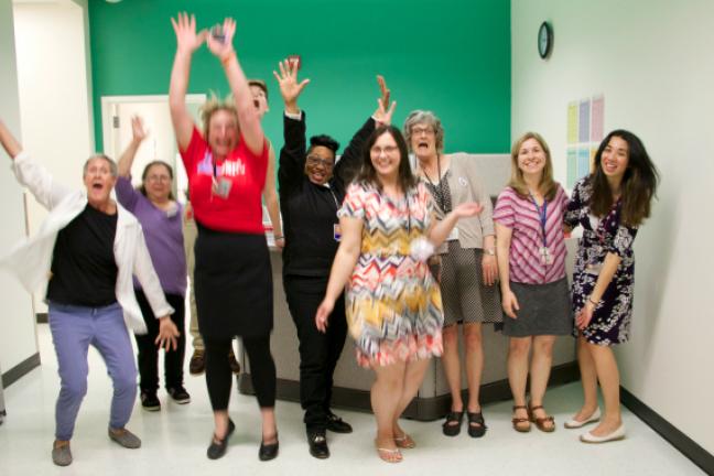 Centennial school-based health center staff jump for joy at the clinic's grand opening.