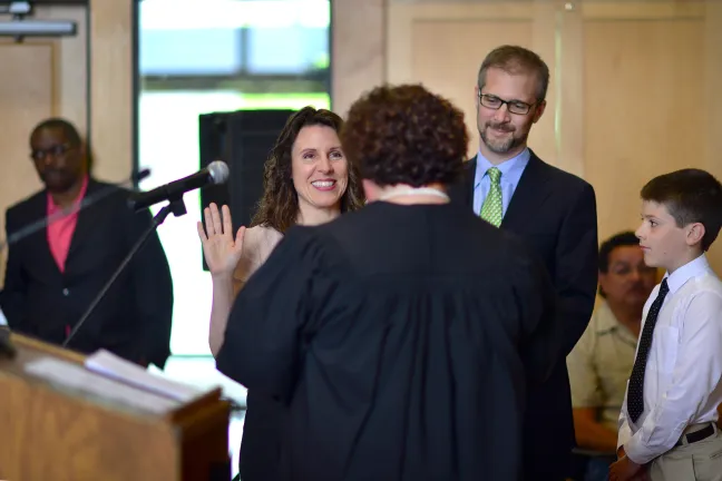 Chair Kafoury takes her ceremonial oath of office from Multnomah County Presiding Judge Nan Waller as her husband Nik and son Jacob look on. 