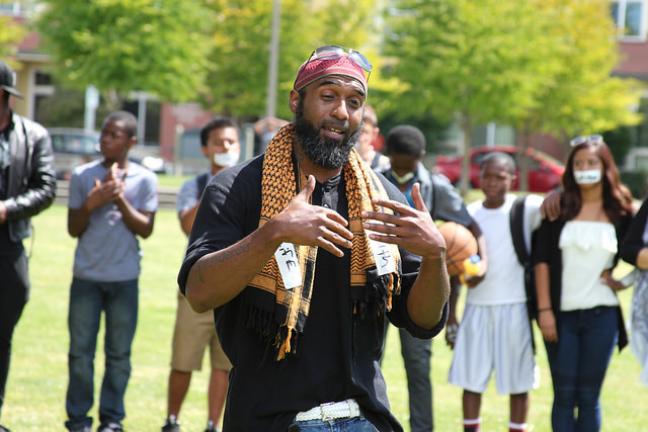 County community health worker Abdullah Hafeedh addresses the crowd at the July 11 peace demonstration. 