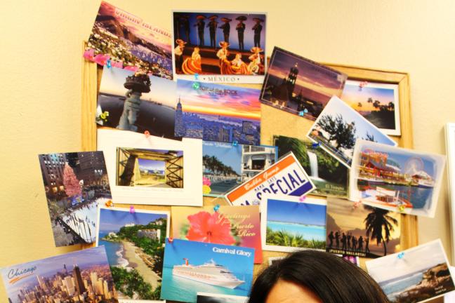 Leticia Longoria-Navarro in front of her postcard collection.