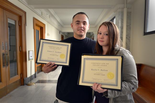 Boyfriend and girlfriend James Gardner and Kayla Ballew proudly display their diplomas following their graduation from the START drug court program on Aug. 20. 