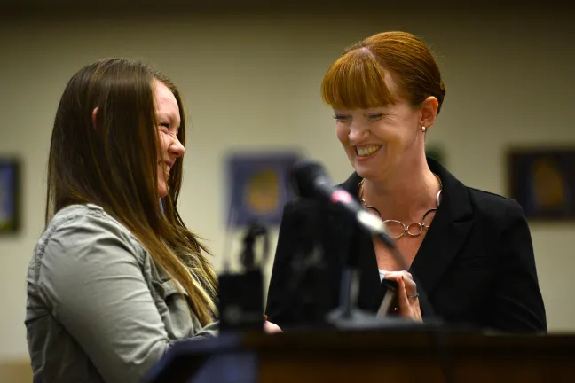 Kayla Ballew receiving her START graduation diploma from her Department of Community Justice Parole and Probation Officer Rochelle Reed on Wednesday, Aug. 20.