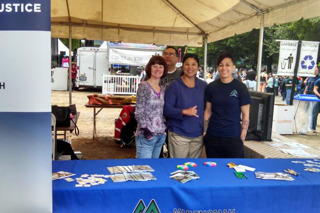 photo of DCJ booth and staff at Portland Pride event