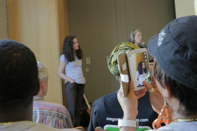 Attendee of Friday's community meeting takes a quick photo of Multnomah County deputy health officer Dr. Jennifer Vines.