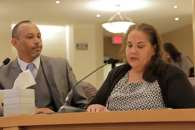 Latino Network’s Alice Perry (right) addresses the board at Thursday's meeting as Alberto Moreno, executive director of the Oregon Latino Health Coalition looks on.