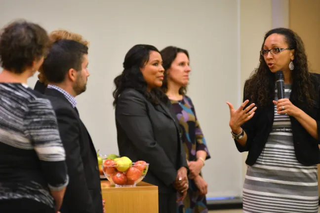 Program director Rachael Banks speaks at Monday's grant announcement celebration as Board of Commissioners look on>