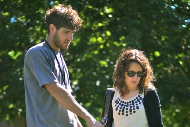 Crew leader Sidney Walters shows Chair Kafoury around the Hands of Wonder garden. 