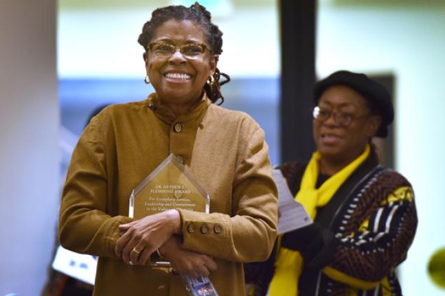Patricia Welch clutches her Arthur Flemming Award at Wednesday's Black History Month celebration.