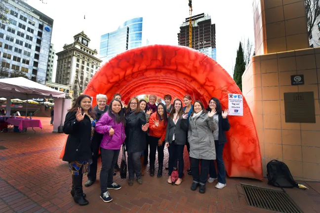 Health Department employees pose under the Strollin Colon, a large inflated cross section of a model colon