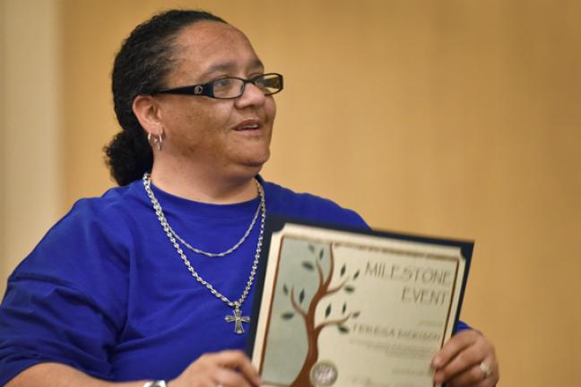 Theresa Dickinson had tears in her eyes while accepting her certificate at the March 5 Milestone Ceremony celebrating DCJ clients who successfully completed 120 days of supervision.