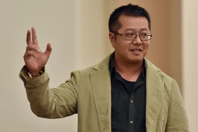 Volunteer of America mentor and former Department of Community Justice client Thi Vu shares his story of recovery at the Milestone Ceremony.