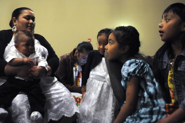 Estephanie Sos prepared to christen her 4-month old son Jepwete Chusauo during a service at the Chuuk Logos Community Church.