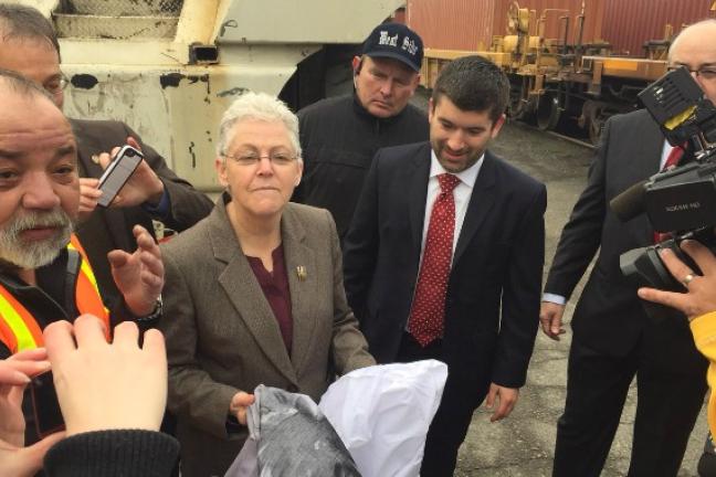 Commissioner Bailey (center) and EPA Administrator McCarthy compare clean and dirty diesel engine examples.