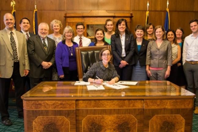 Gov. Kate Brown signs e-cigarette ban into law.