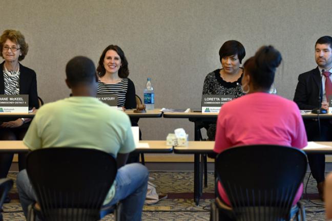 Board of Commissioners listen intently as Dontae and Sylvia Wiley talk about their nonprofit that helps at-risk youth.