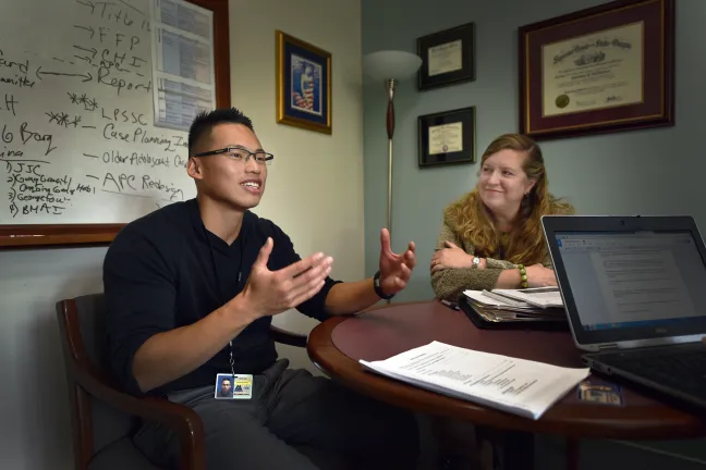 Sang Dao smiles as he shares his story of redemption. His supervisor and mentor Christina McMahan looks on proudly.