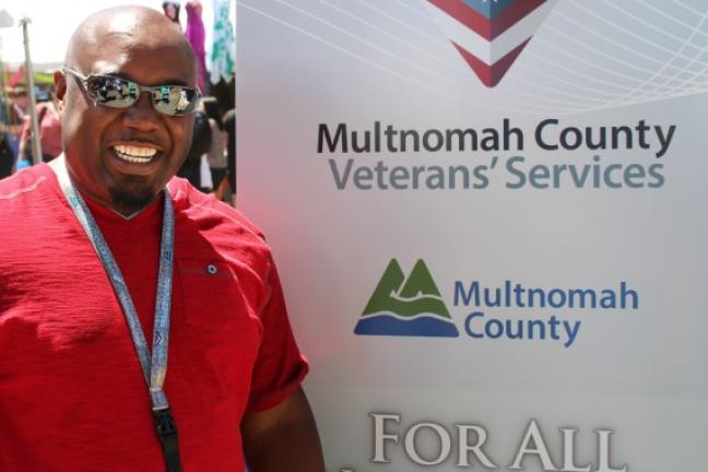 Eric Ensley with new vet outreach banner during PRIDE 2015.