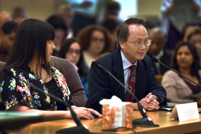 Lee Po Cha, executive director of the Immigrant and Refugee Community Organization, addresses the board before the budget adoption on Thursday morning.