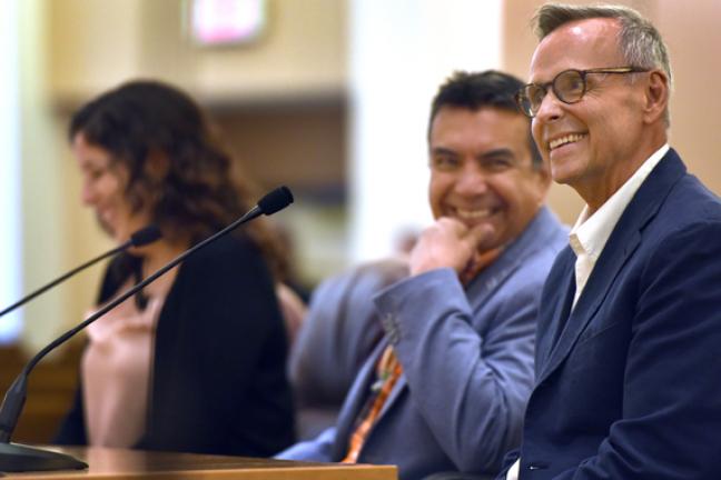 John Halseth addresses the board on Thursday as his husband Robin Castro (center) smiles on 