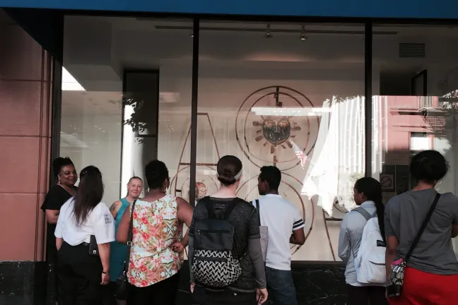 Terresa discusses the exhibit with students and employees.