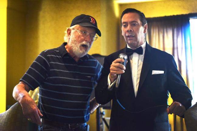 John English sings with audience member in the lounge at the Clarion Airport Hotel