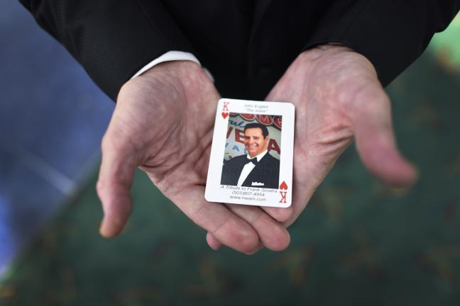 John English holds his good luck, king of hearts business card