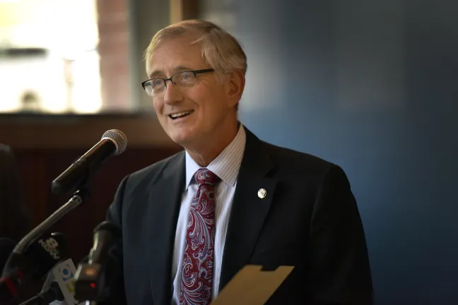 Mayor Hales speaks into a microphone from a podium.