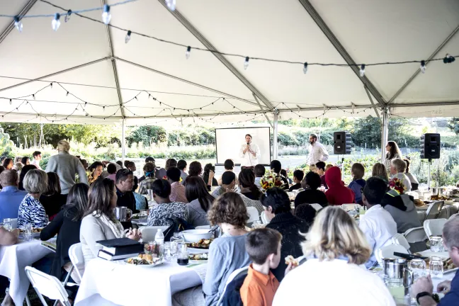Attendees of JSD's 2015 Farm to Table event listen to a speech. 