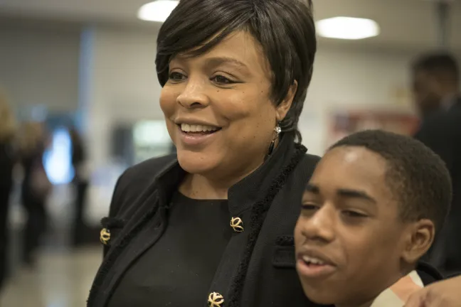 Eighth grader Montre Harris poses for a picture with Commissioner Loretta Smith.