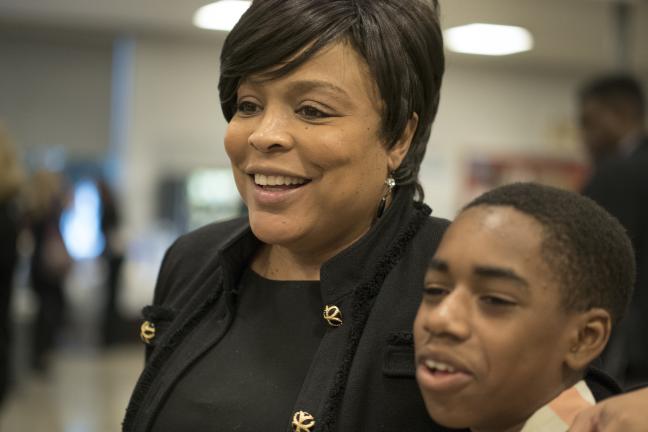 Eighth grader Montre Harris poses for a picture with Commissioner Loretta Smith. 