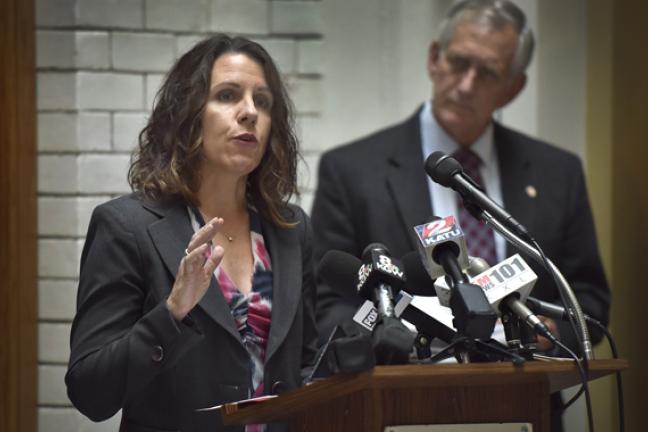 Chair Kafoury addresses the crowd at Wednesday's press conference as Mayor Hales looks on.