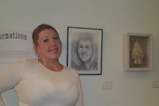 Alison S. poses next to her artwork.