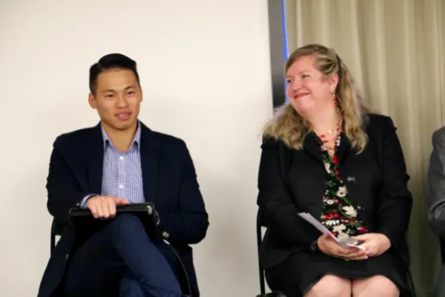 Sang Dao and Christina McMahan speak on stage.  
