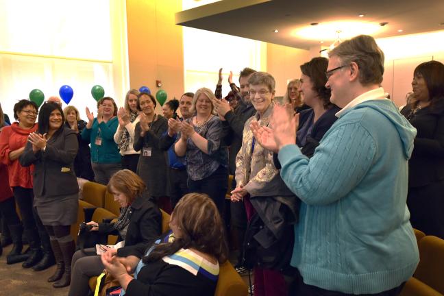 Ceremony attendees give a standing ovation to Librarian Janet Irwin, who has been with the county for 45 years.