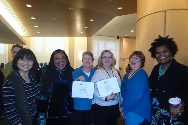 DCJ staff pose for the camera at the 2015 years of service ceremony