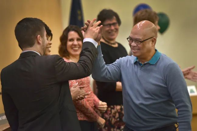 Commissioner Jules Bailey high-fives Department of County Human Services’ Gary Miguel. Miguel has been with Multnomah County for 15 years.