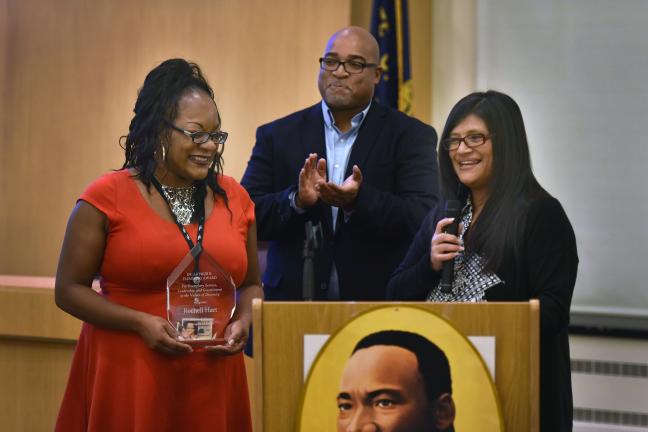 Case manager Rochell Hart (left) recieves the 2016 Arthur S. Flemming Award from Managers of Color members Mark Lewis and Irma Jimenez.