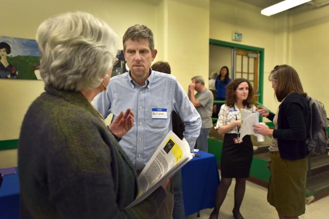 Health Officer Dr. Paul Lewis, center, and Deputy Health Officer, Dr. Jennifer Vines, second from right, talk to neighbors about high levels of heavy metals in recent air testing.