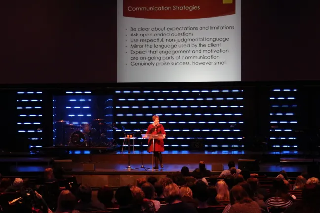 Portland State University assistant professor Christiana Bratiotis addresses a crowd of more than 700 at Tuesday's workshop.