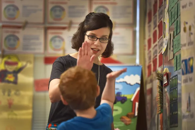 Alia Woolfe high fives one of her pupils at Lincoln Park Elementary School.