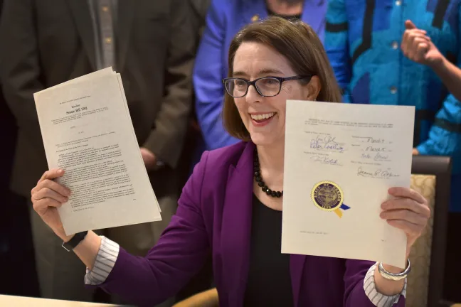 Governor Kate Brown holds up critical housing bills passed during the 2016 legislative session
