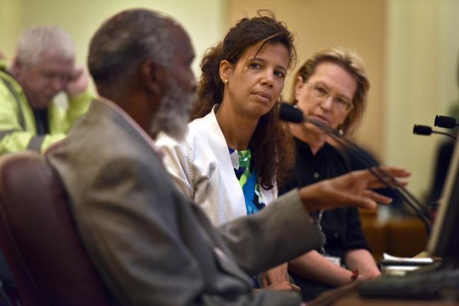 john a. powell addresses the board as Health Department Director Joanne Fuller (right) and Public Health Director Tricia Tillman (center) look on.