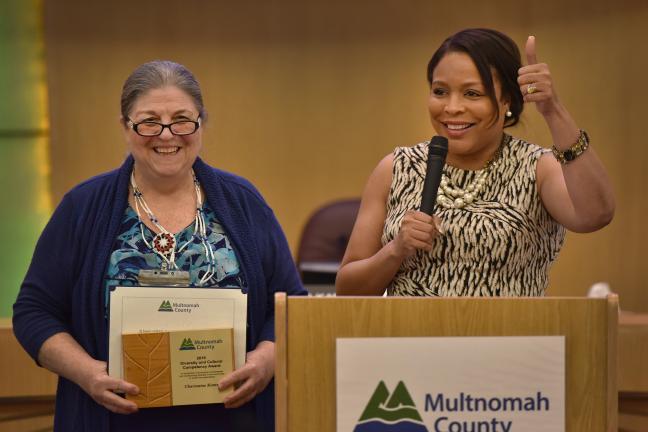 Commissioner Loretta Smith (right) presents Charmaine Kinney with her Diversity and Cultural Competency Award.