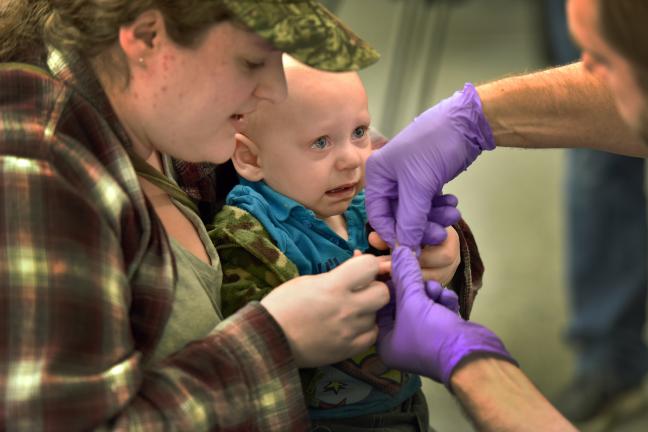 County lead specialist Perry Cabot tests a teary-eyed Luke Klassen as he is comforted by his mother Nikki Meyers.