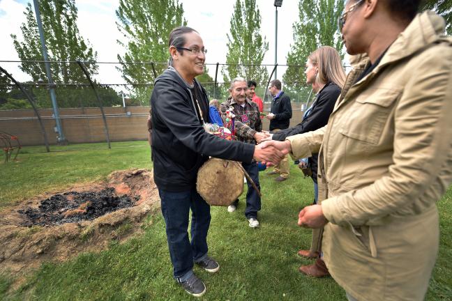 Latino Network care manager Rodolfo Serna and corrections technician Keyunna Baker greet each other during the blessing ceremony. 